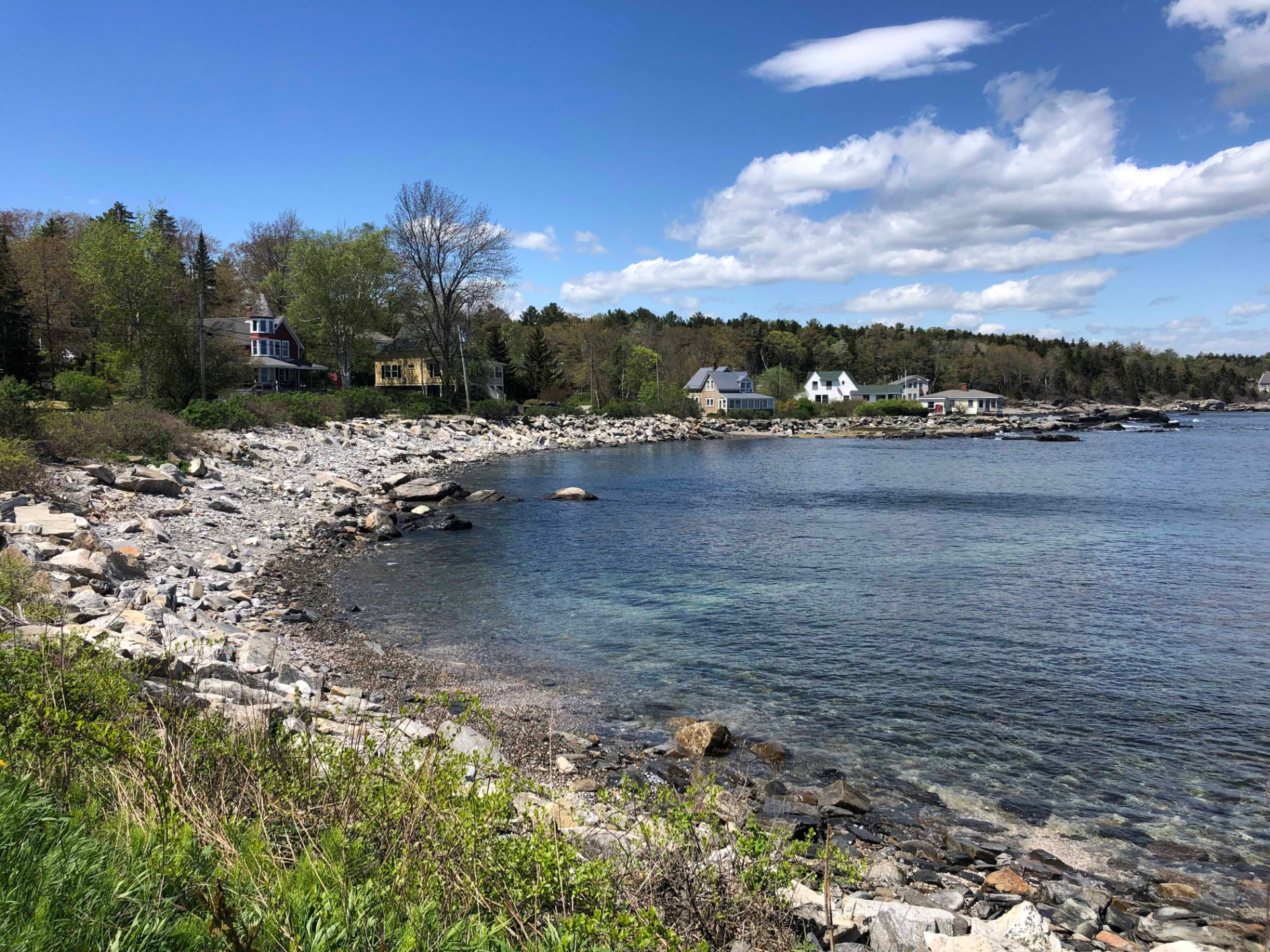 Spar Cove shoreline on Peaks Island with clear water and coastal cottages
