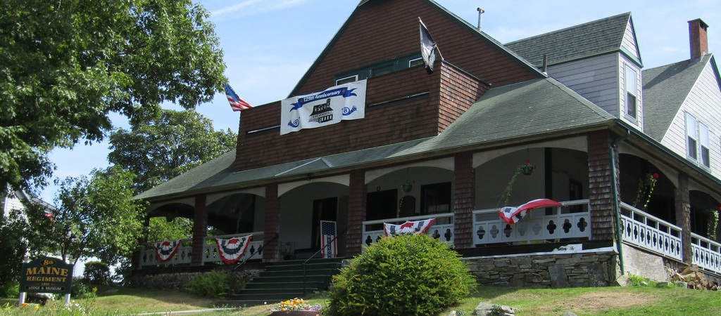 The 8th Maine Regiment Lodge and Museum with its wraparound porch and bunting