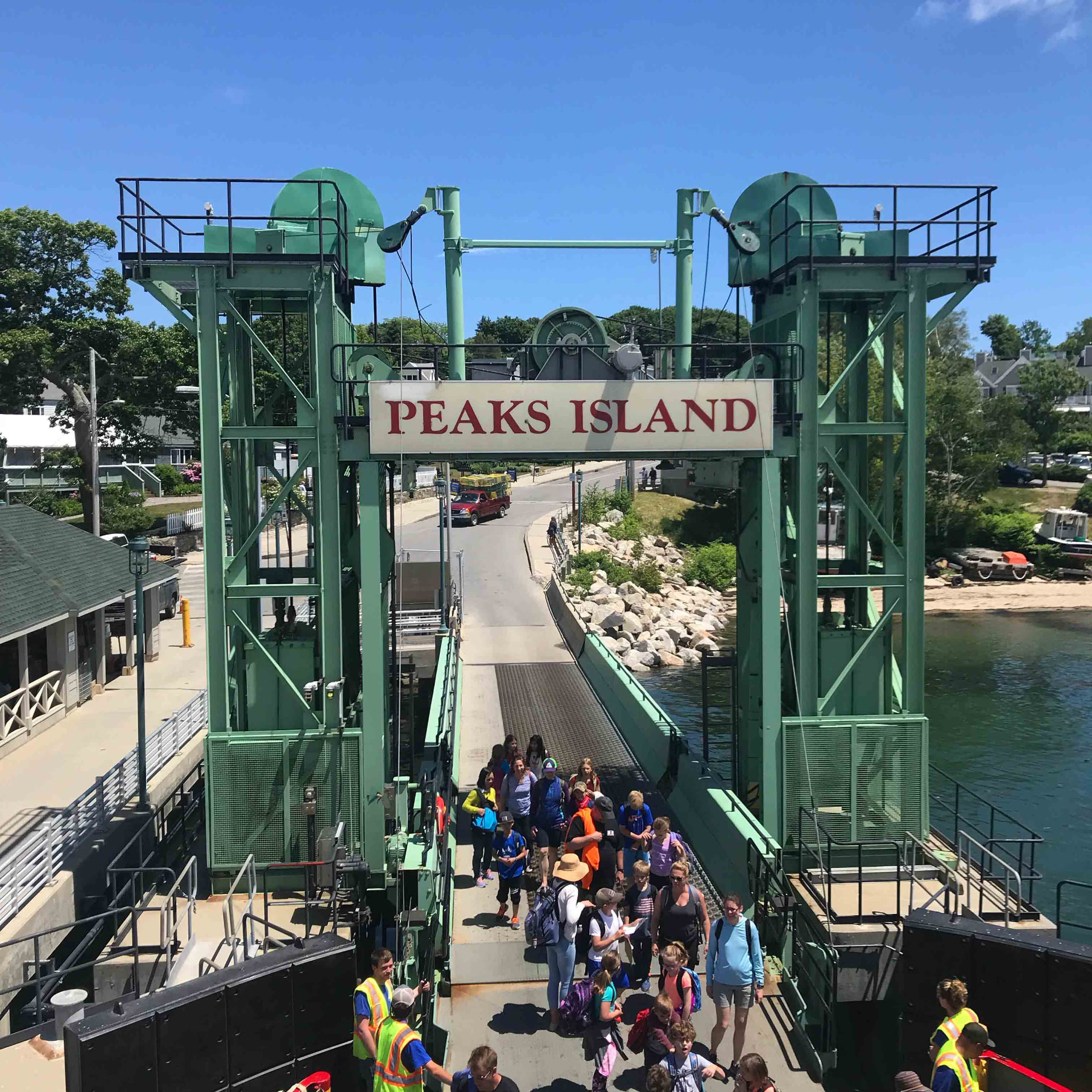 Passengers walking off the Casco Bay ferry under the Peaks Island sign